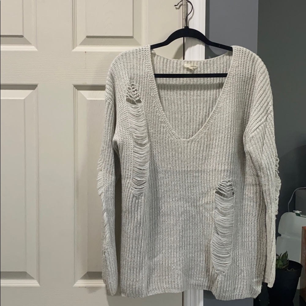 Grey knit sweater with accented rips
